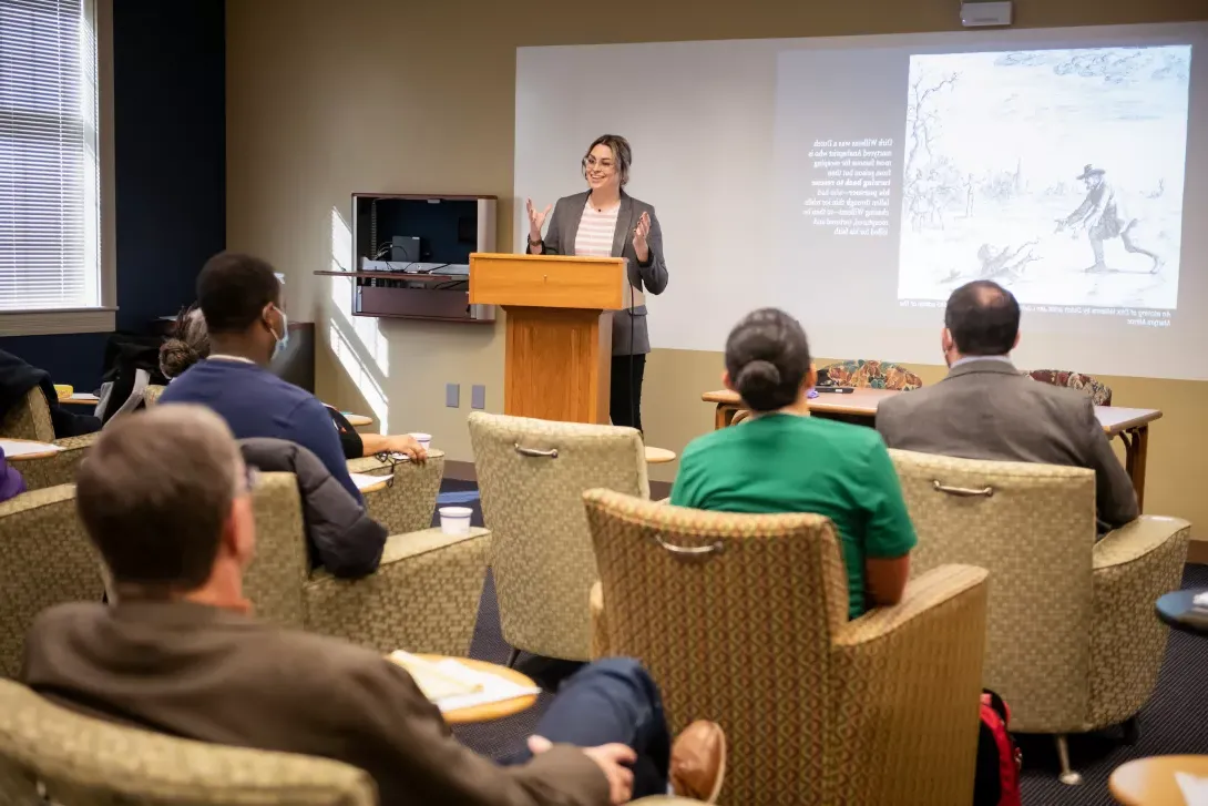 Guest speaker at podium during Symposium Against Indifference